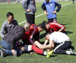 Ayağı kırılan futbolcu, sedye olmadığı için kucakta taşındı